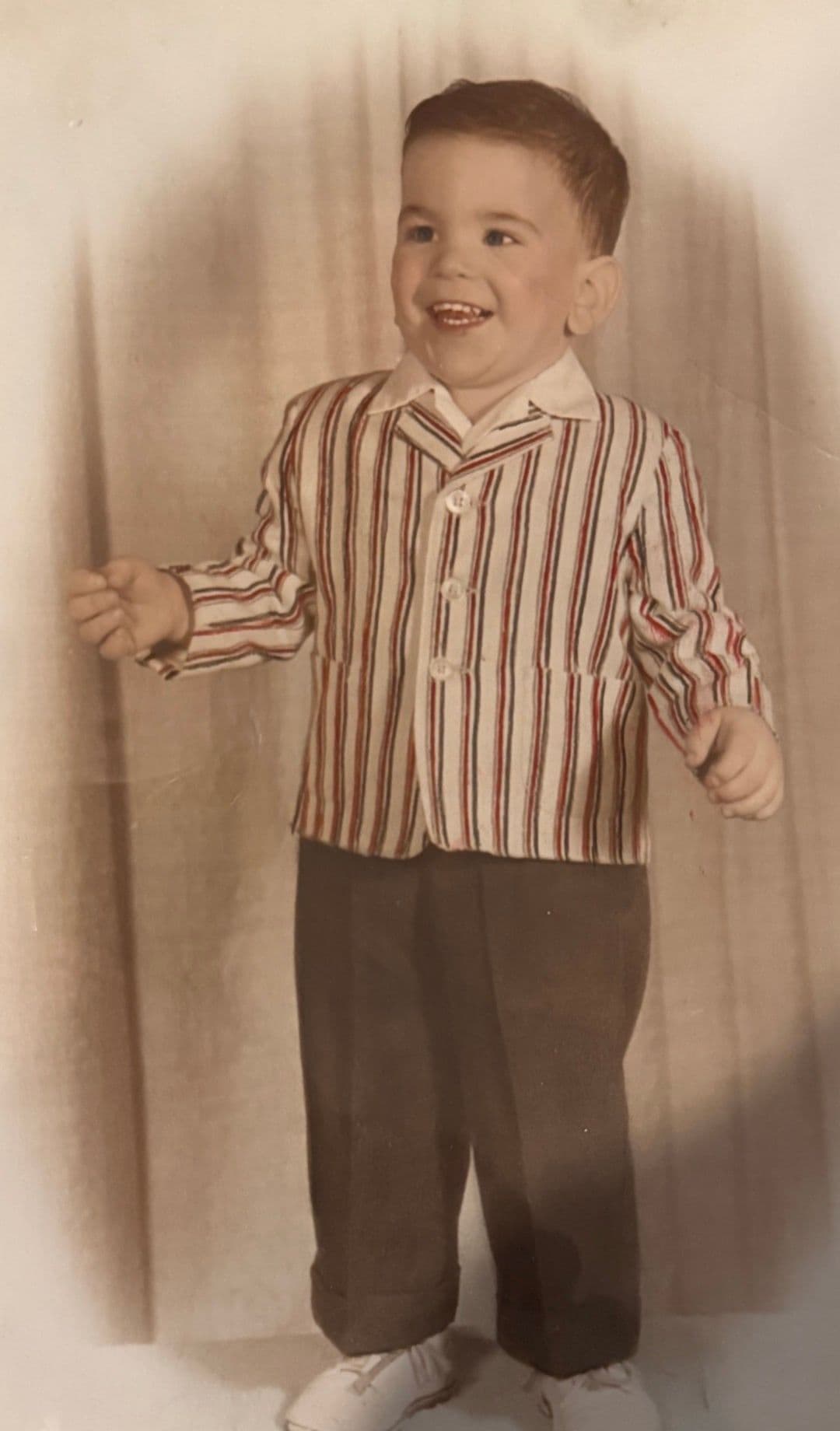 David Arnowitz as a toddler, about three, in a striped jacket